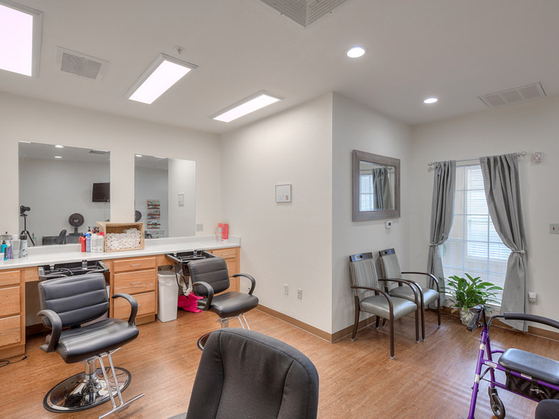 Interior view of a beauty salon with chairs and mirrors
