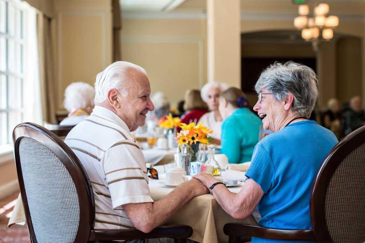 Residents enjoying a meal together in the dining room