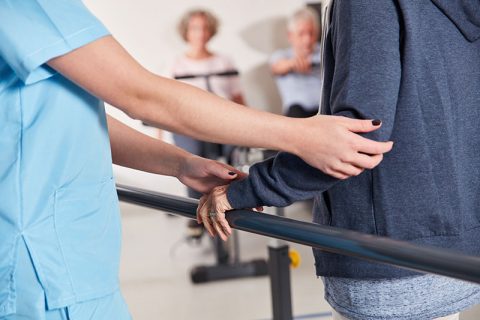 Staff assisting a resident during a therapy session
