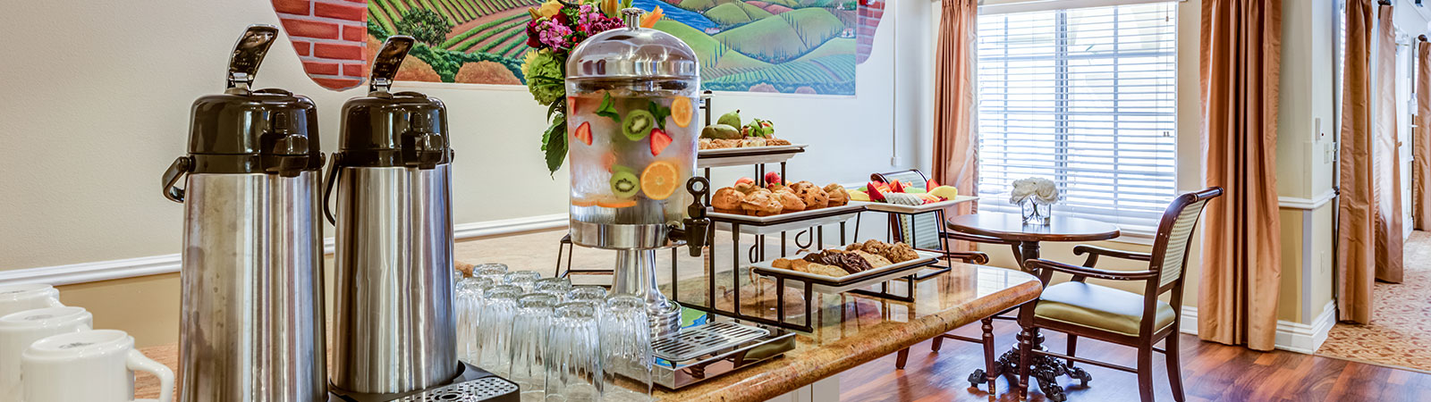 Brightly lit dining area with refreshments and pastries