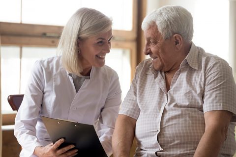 Healthcare professional interacting with a senior resident
