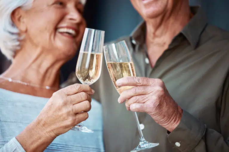 Older couple toasting with champagne glasses