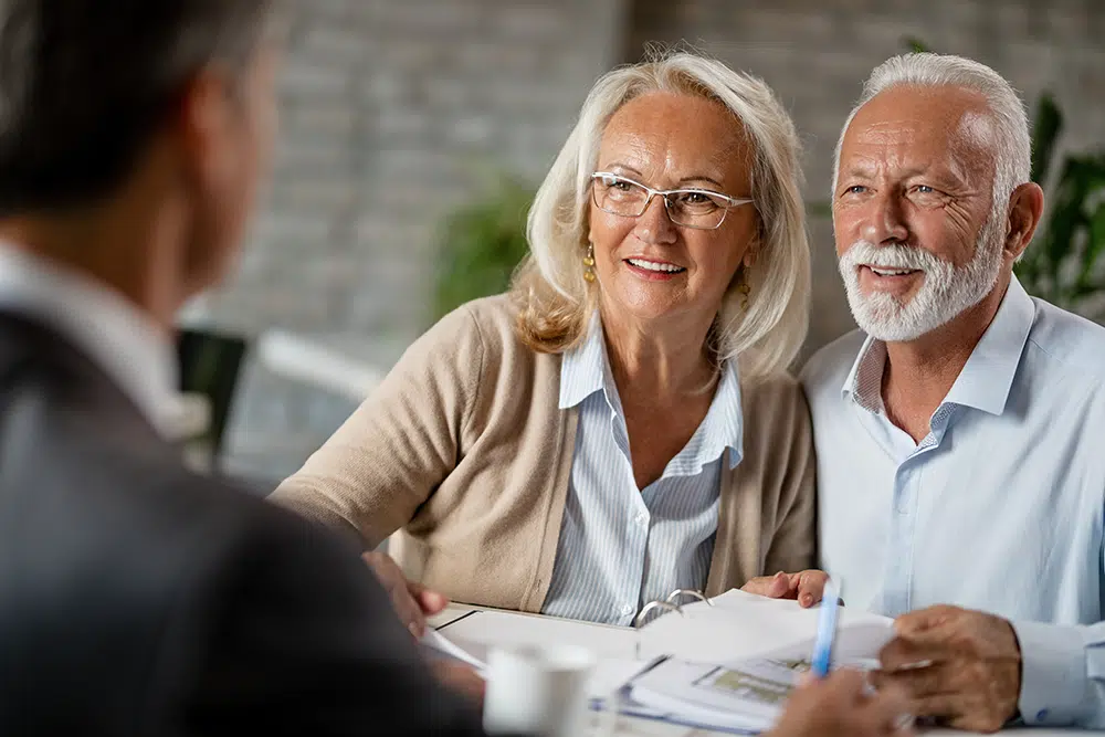 Couple engaging in conversation with staff in a common area