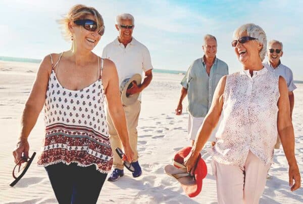 Seniors enjoying a walk on the beach
