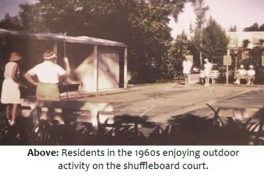 Residents enjoying shuffleboard in a vintage outdoor setting.