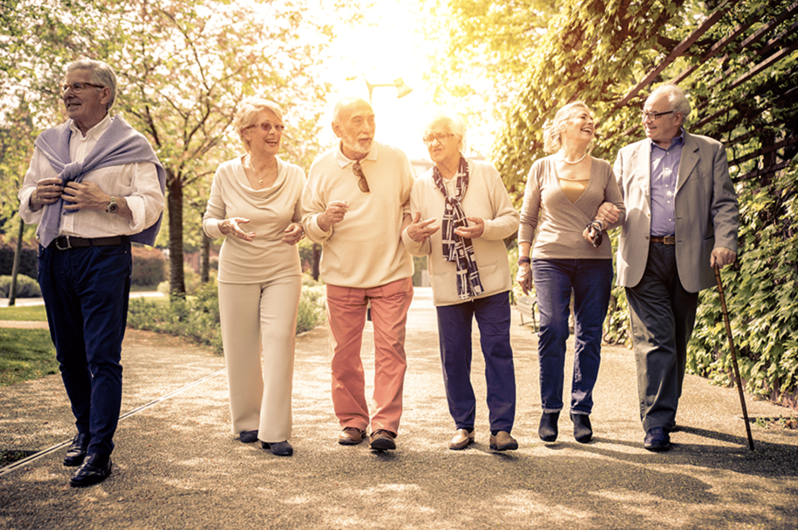 Residents enjoying a walk in a sunlit garden