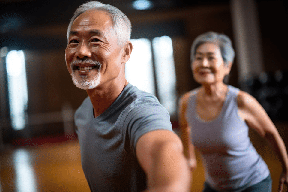 Two seniors smiling during a fitness class