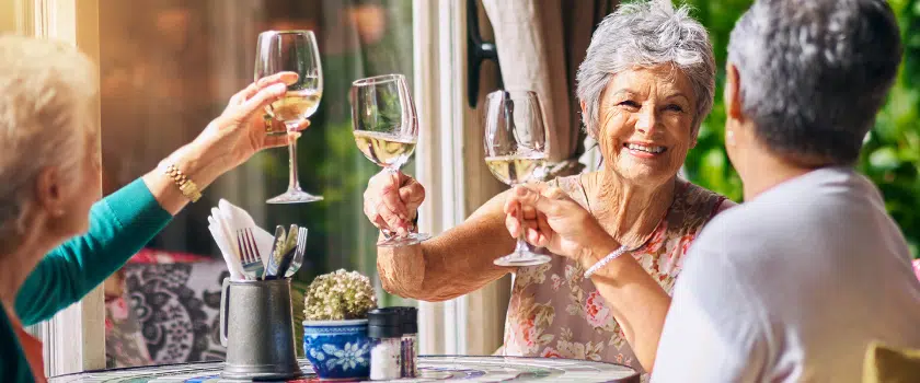 Residents celebrating with glasses raised at a table