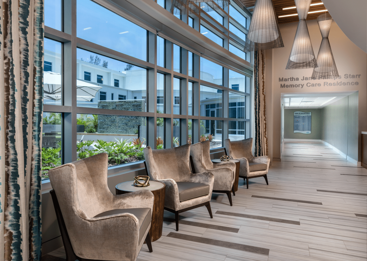 Bright common area with seating and large windows