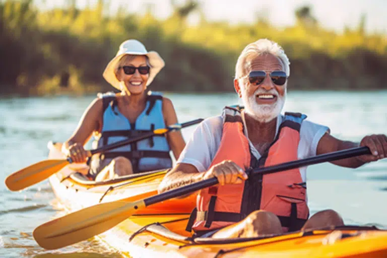 Seniors kayaking together on a sunny day