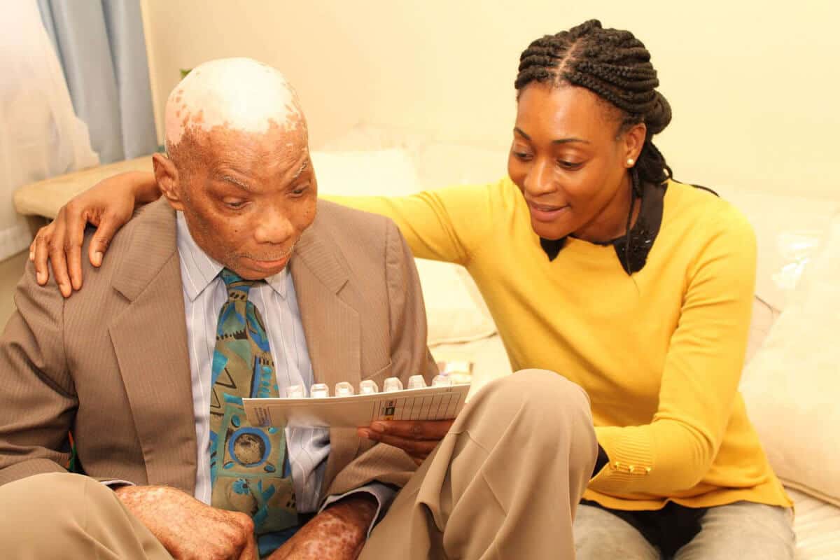 Caregiver engaging with a resident in a cozy room.