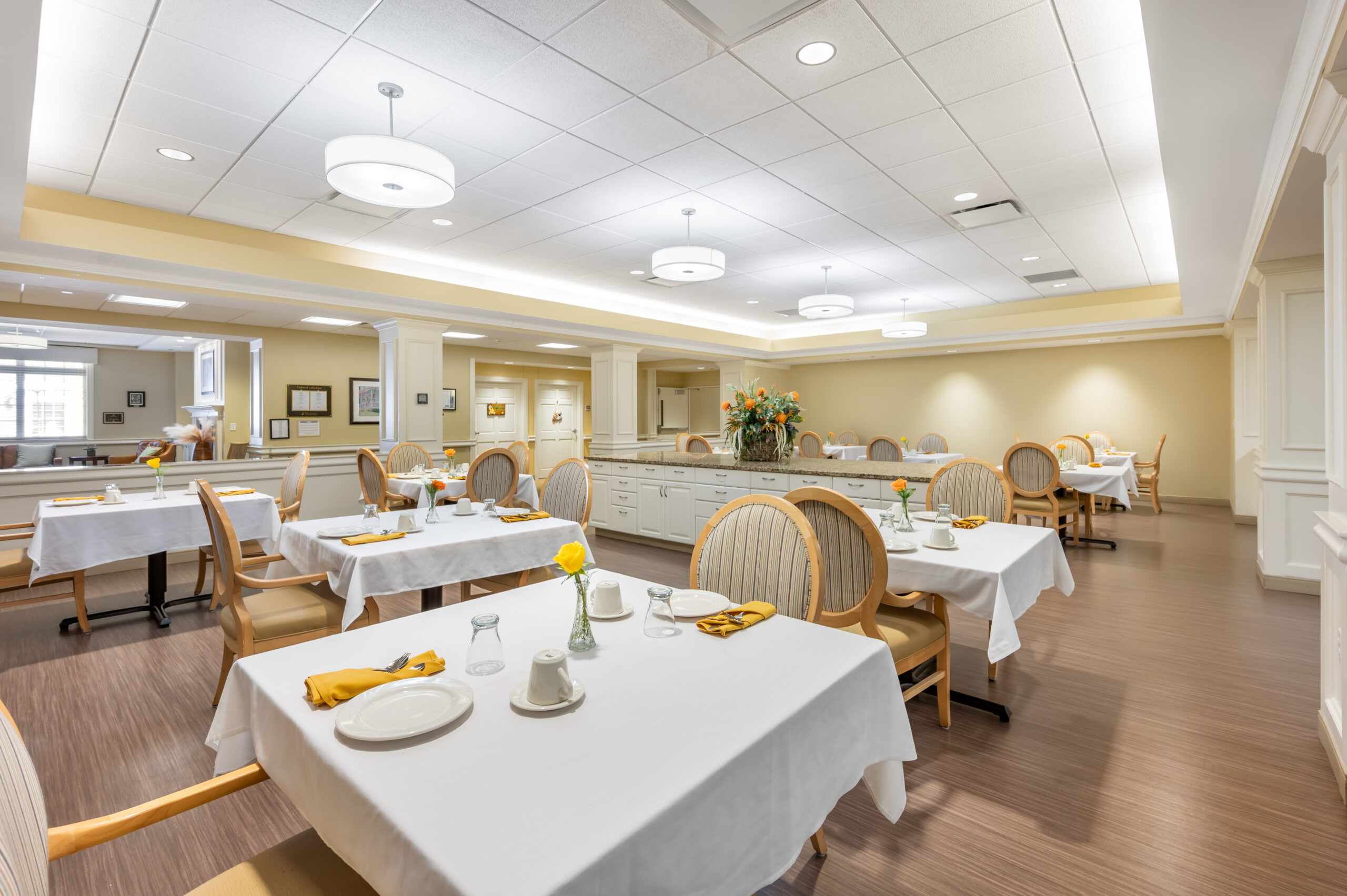 Bright dining room with tables set for meals