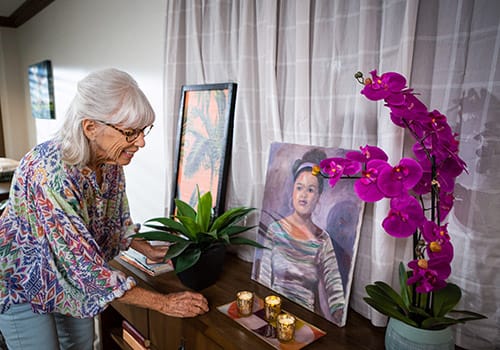 Resident arranging flowers in a cozy room