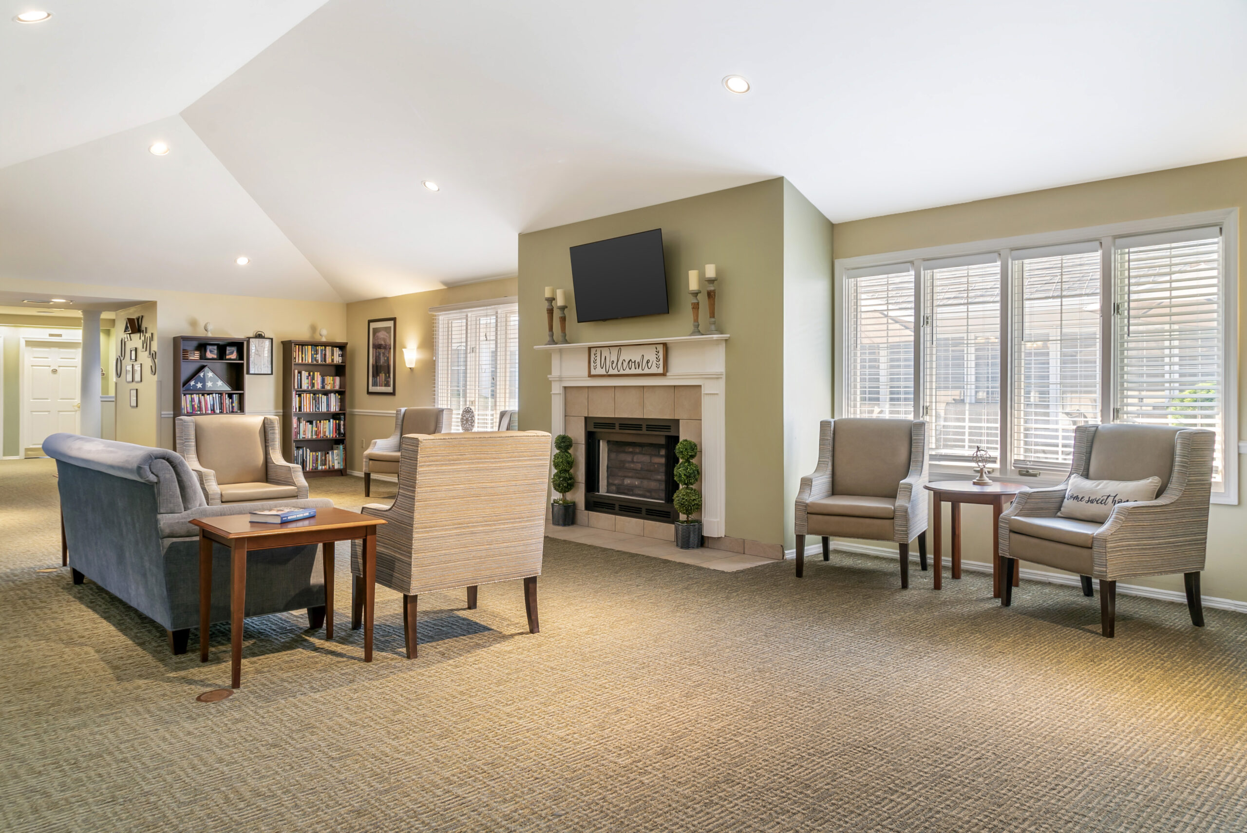 Bright common area with seating and a fireplace