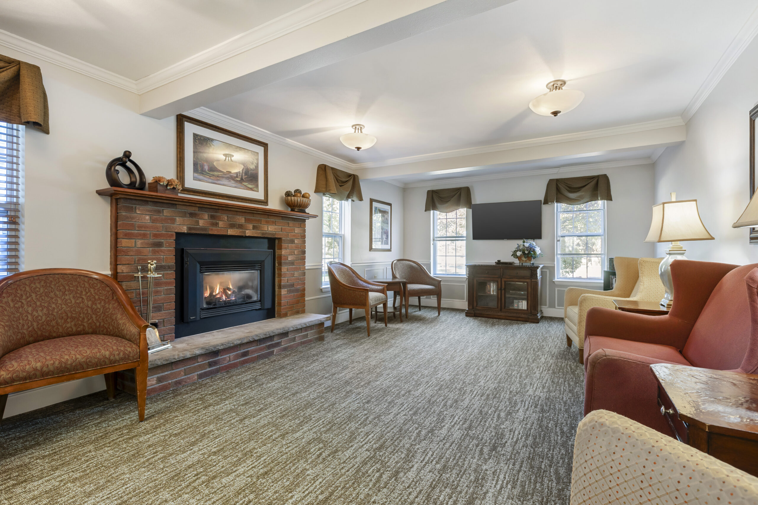 Bright common area with seating and a fireplace