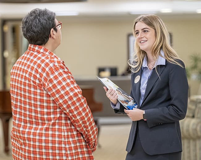 Staff member engaging with a resident in the lobby area
