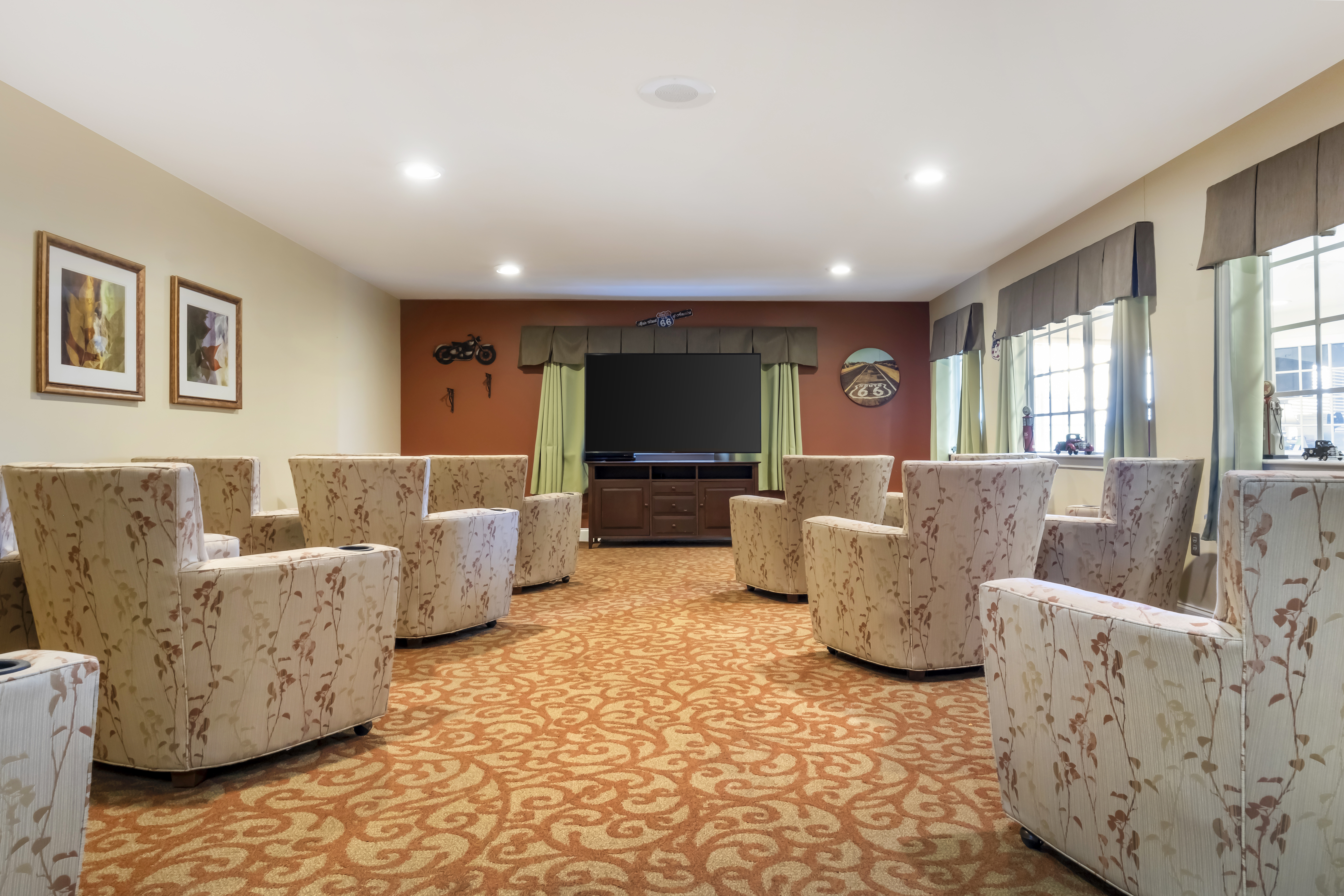 Bright common area with armchairs and a television