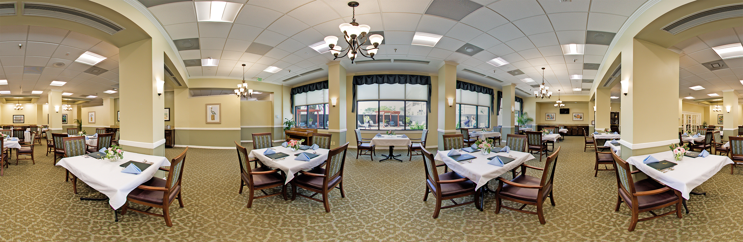 Bright dining room with table settings and natural light