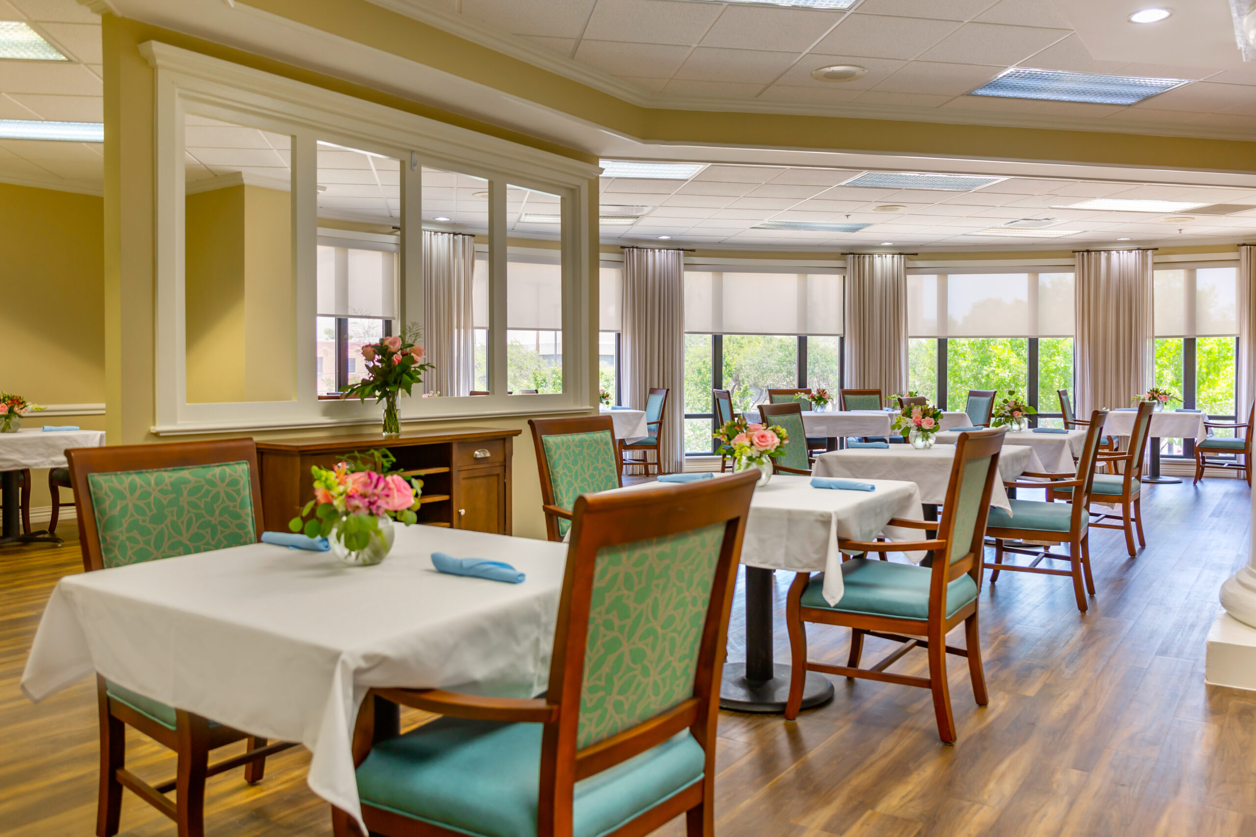 Bright dining area with tables and chairs set up