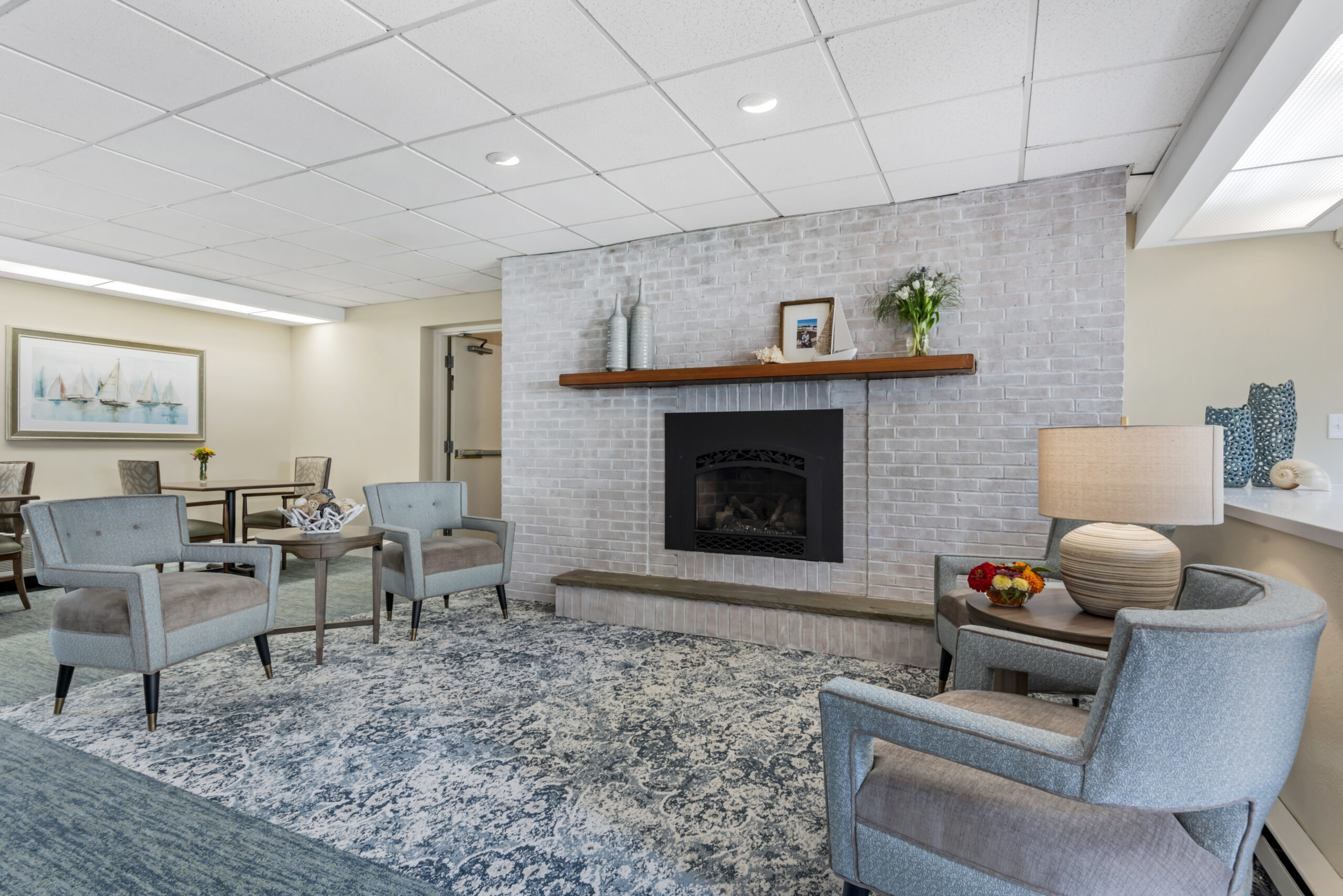 Bright interior lounge area with seating and fireplace