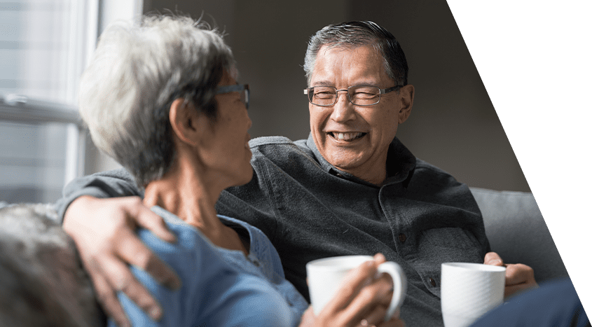 Senior couple enjoying coffee together in a cozy common area