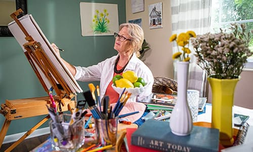 Resident painting in an art activity setting