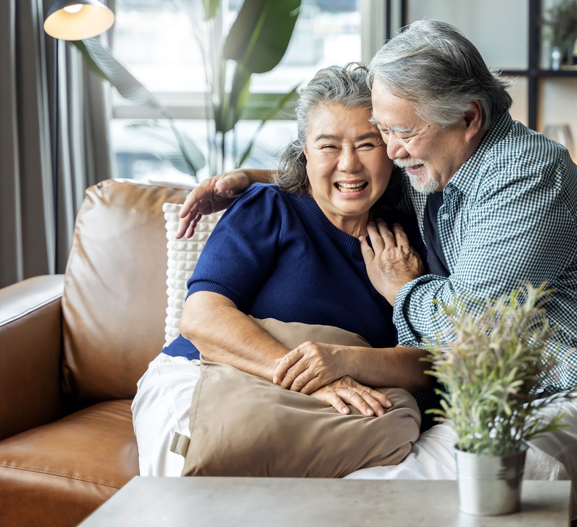 Two seniors enjoying a cozy moment on a couch