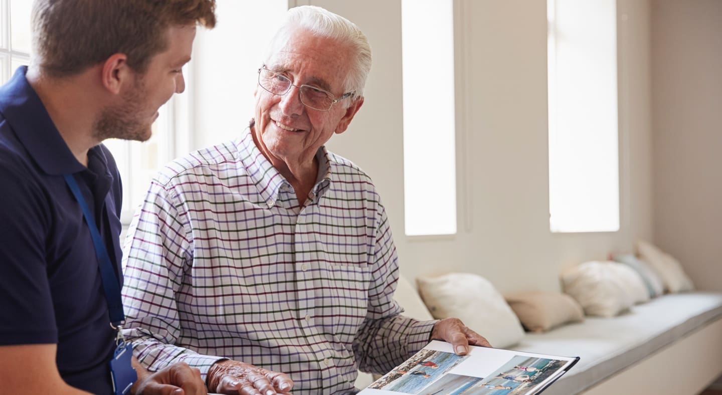 Staff member engaging with a resident in a bright common area