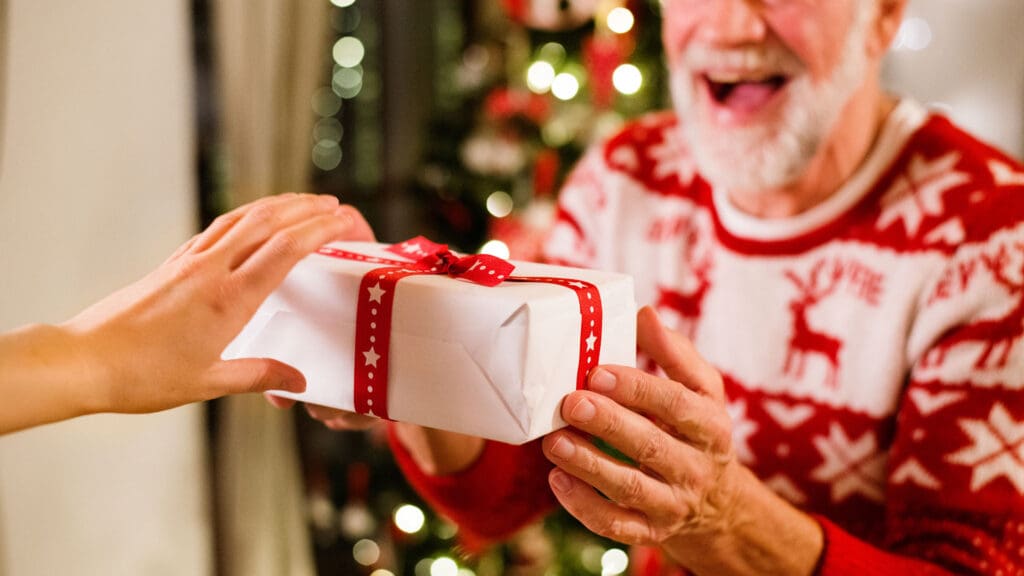 Resident joyfully receiving a gift during a celebration