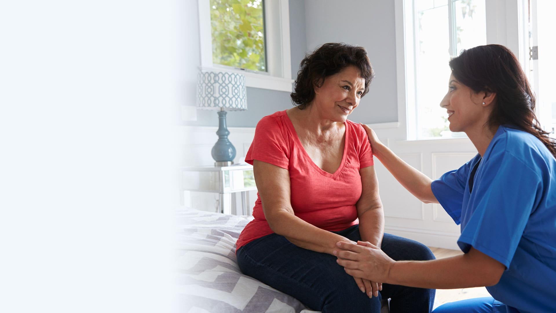 Caregiver supporting a resident in a bright interior setting