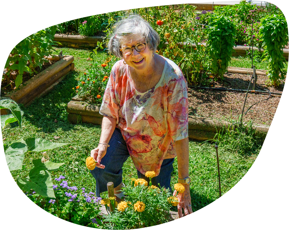 Resident gardening in a vibrant outdoor garden