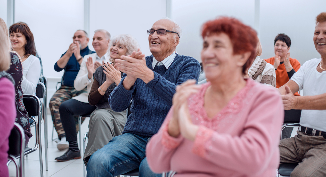 Residents enjoying a performance in a common area