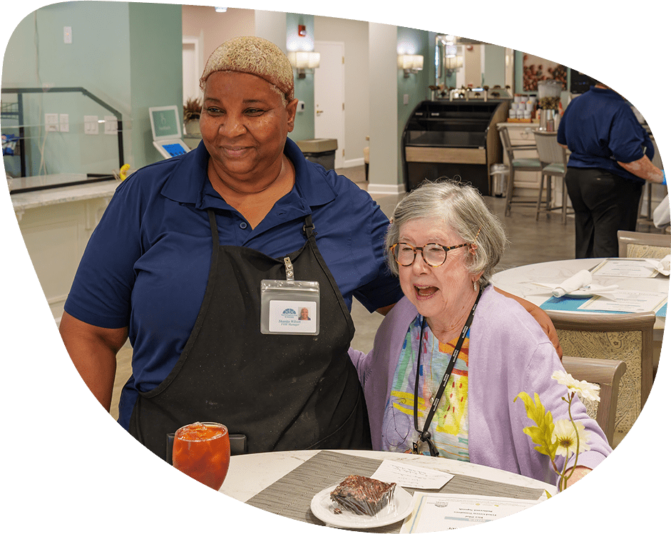 Staff member with resident in a dining area