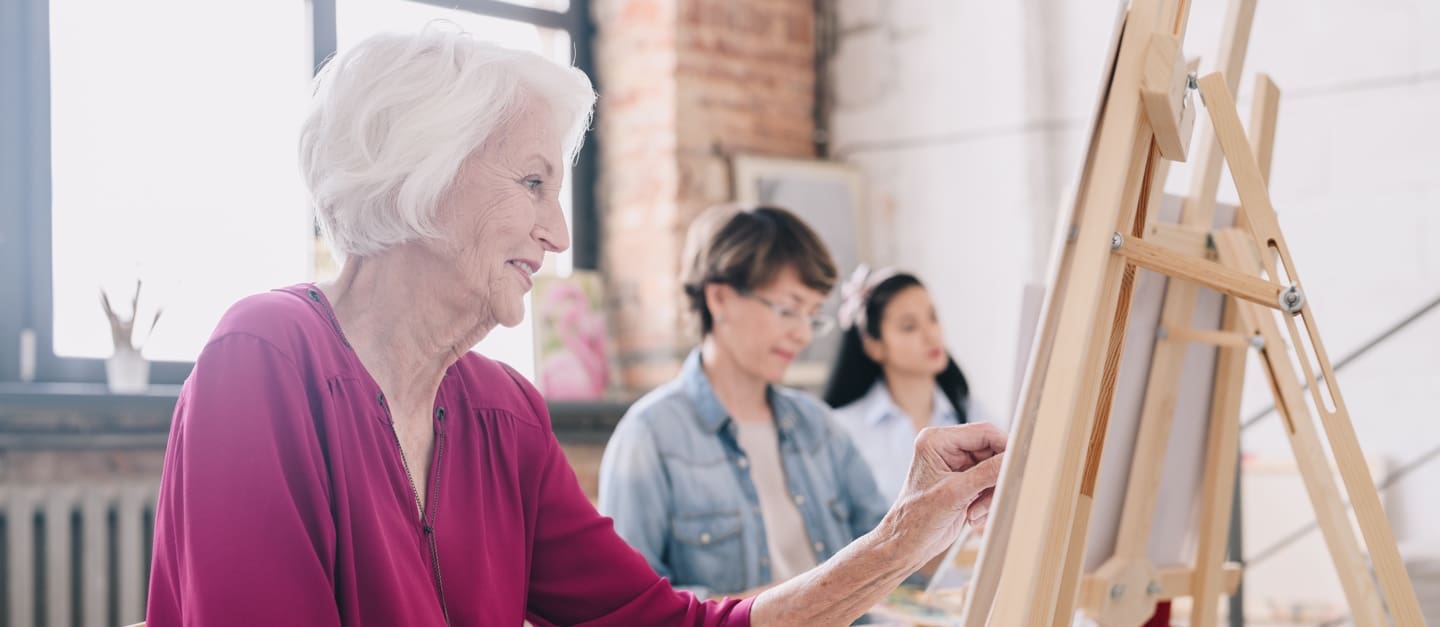 Residents painting in an art class
