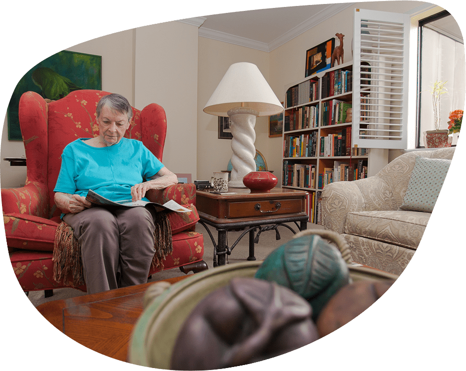 Resident reading in a cozy common area