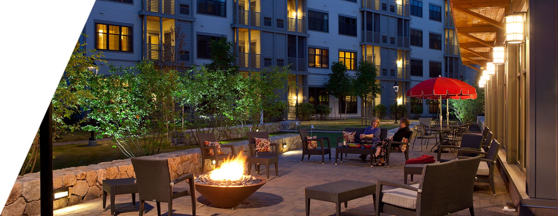 Residents enjoying an evening by the outdoor firepit