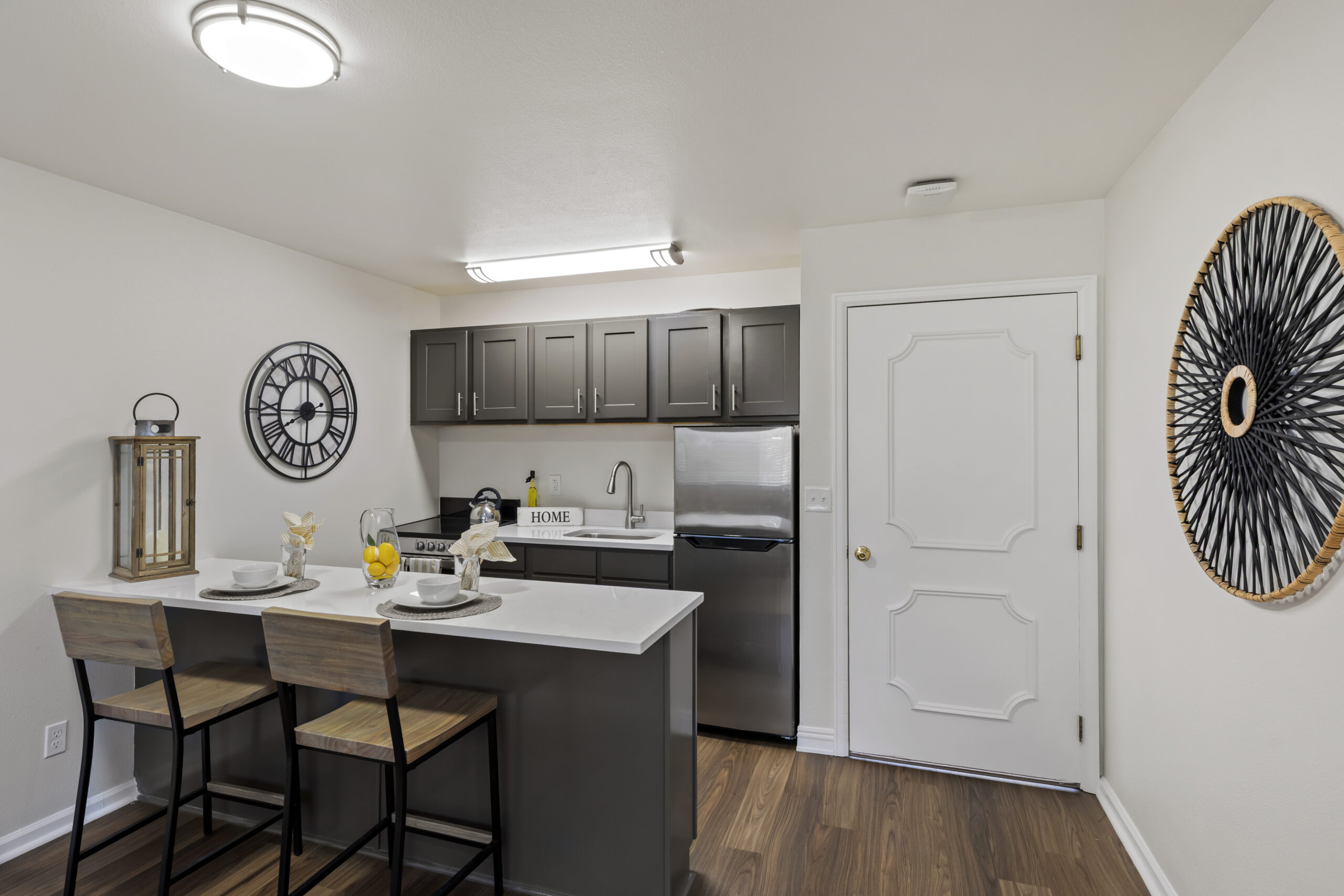 A modern kitchen area with seating.