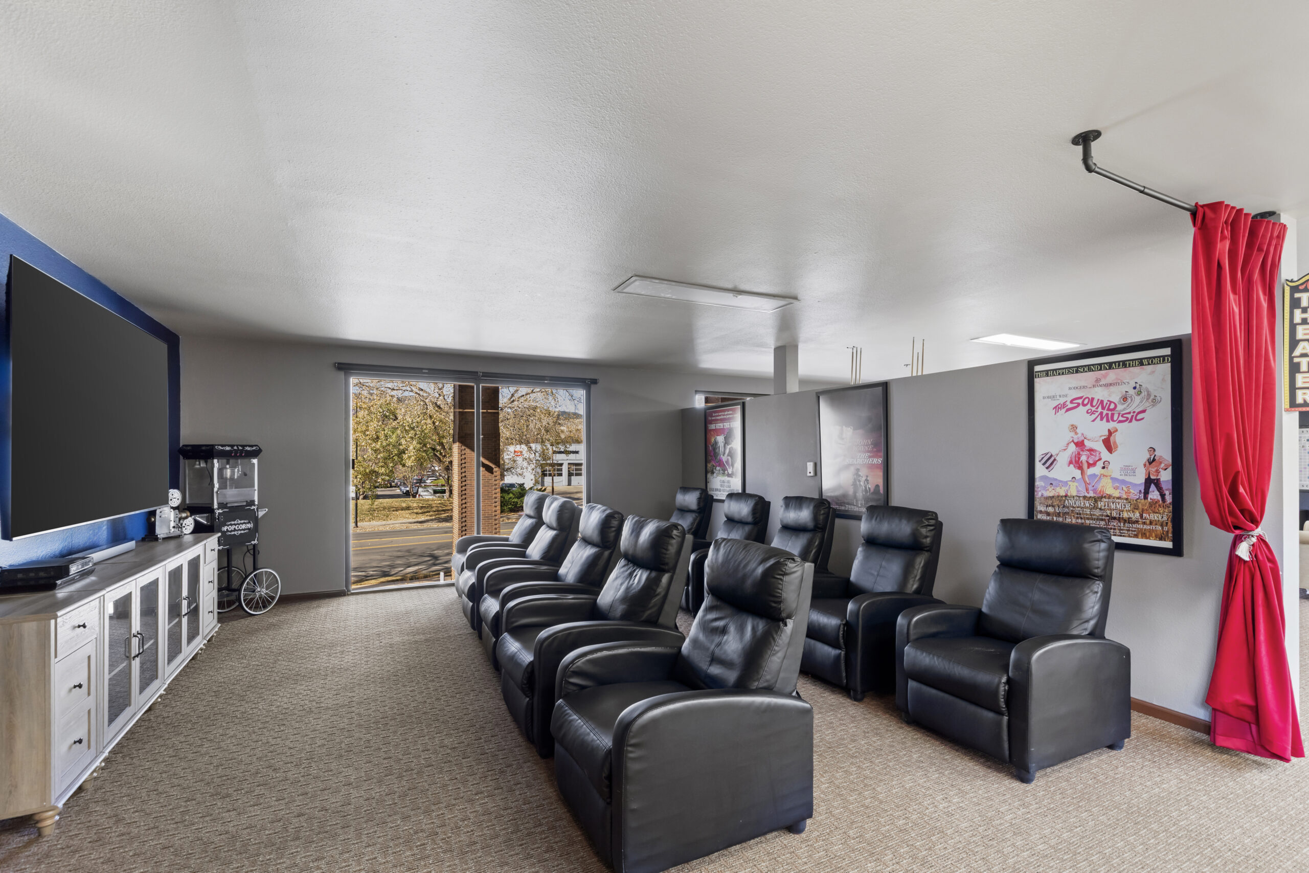 Comfortable common area with reclining chairs and a large screen