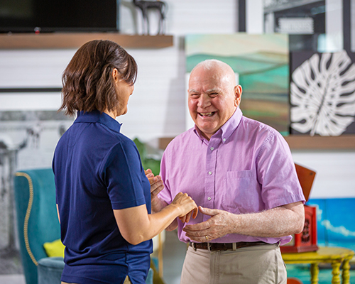Staff member engaging with a smiling resident