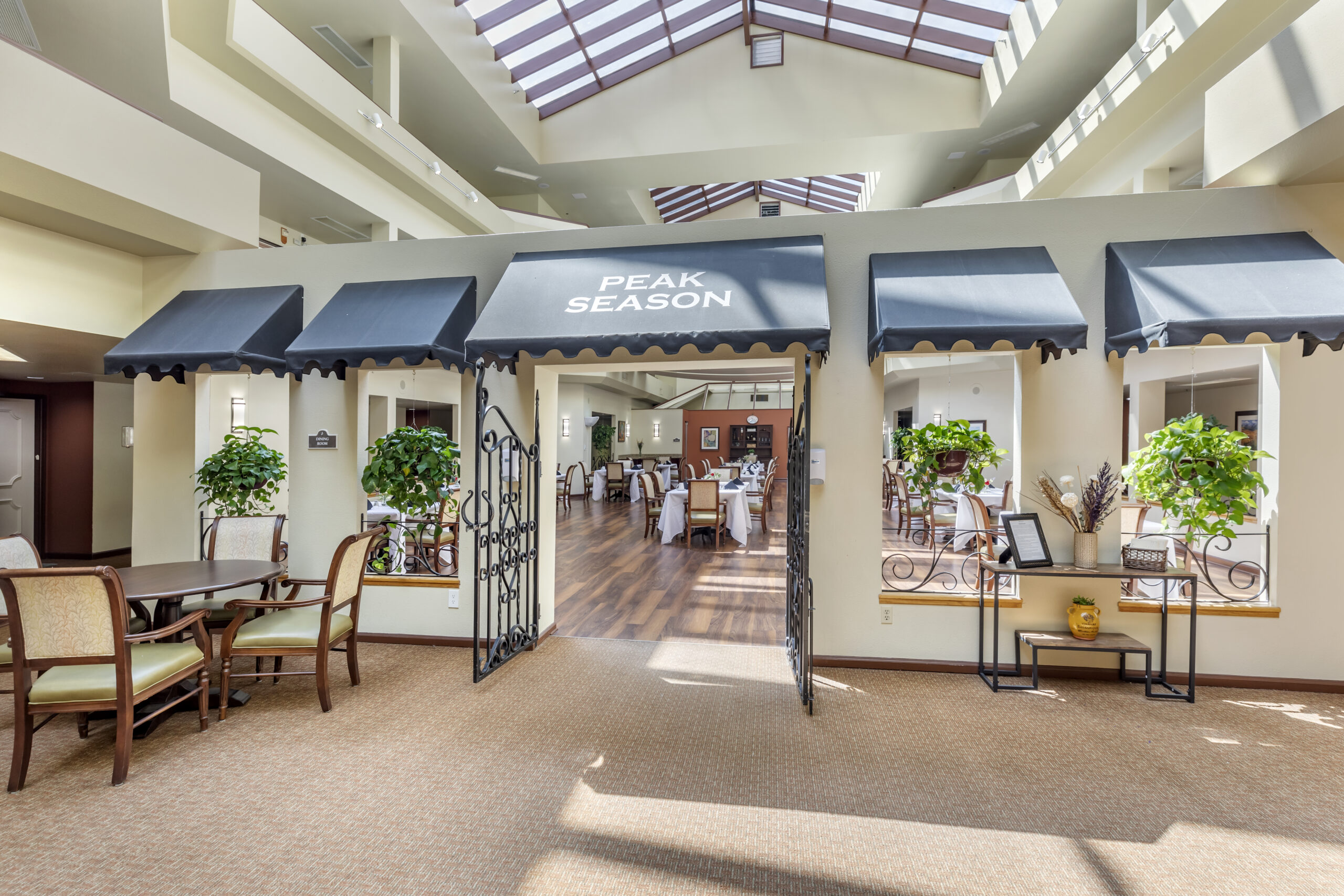 Interior dining area with decorative seating and plants