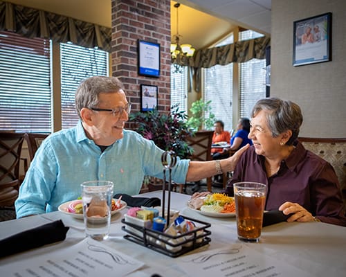 Residents enjoying a meal together in the dining room
