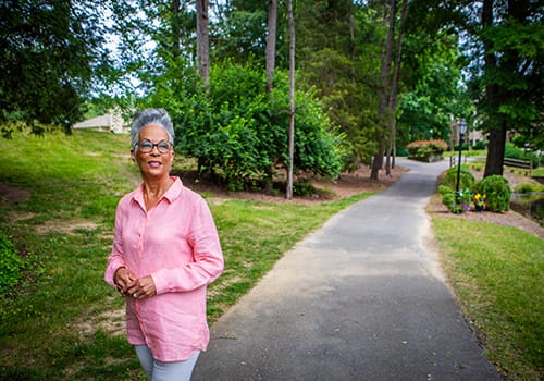 Resident enjoying a walk in the outdoor space