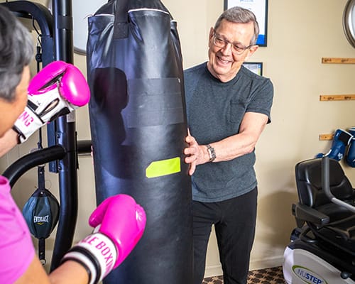 Residents engaging in a boxing activity in the gym