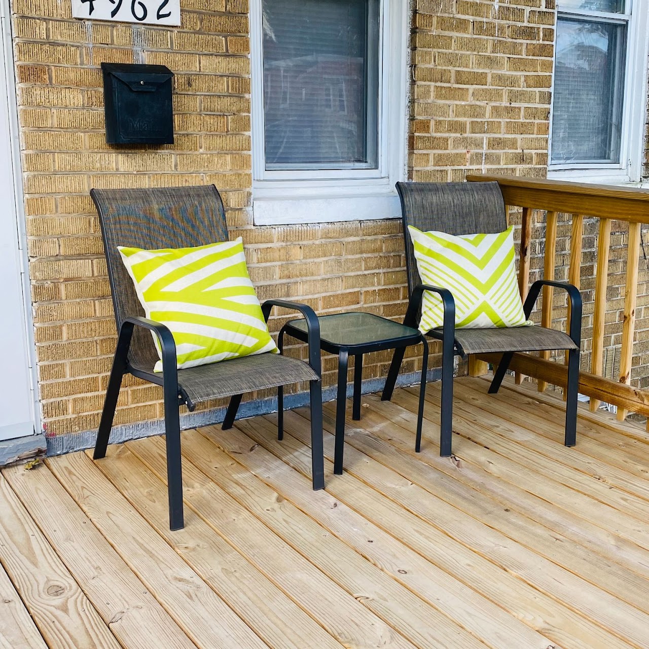 Outdoor seating area with chairs and decorative pillows