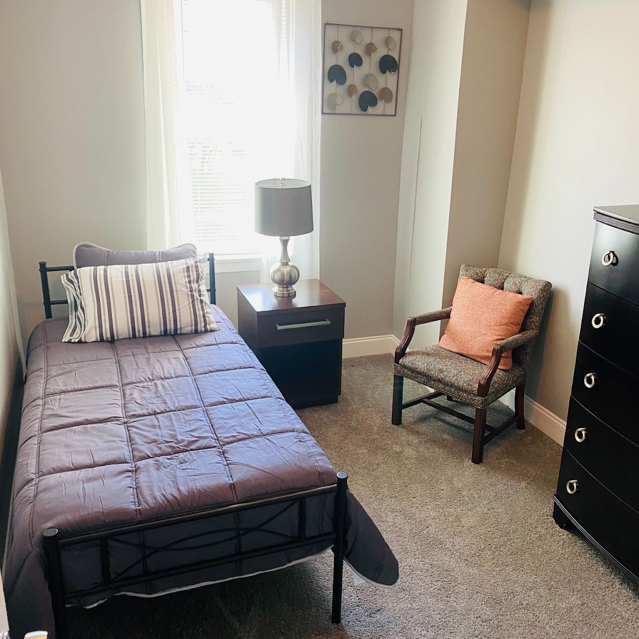 Cozy private bedroom with a bed and chair