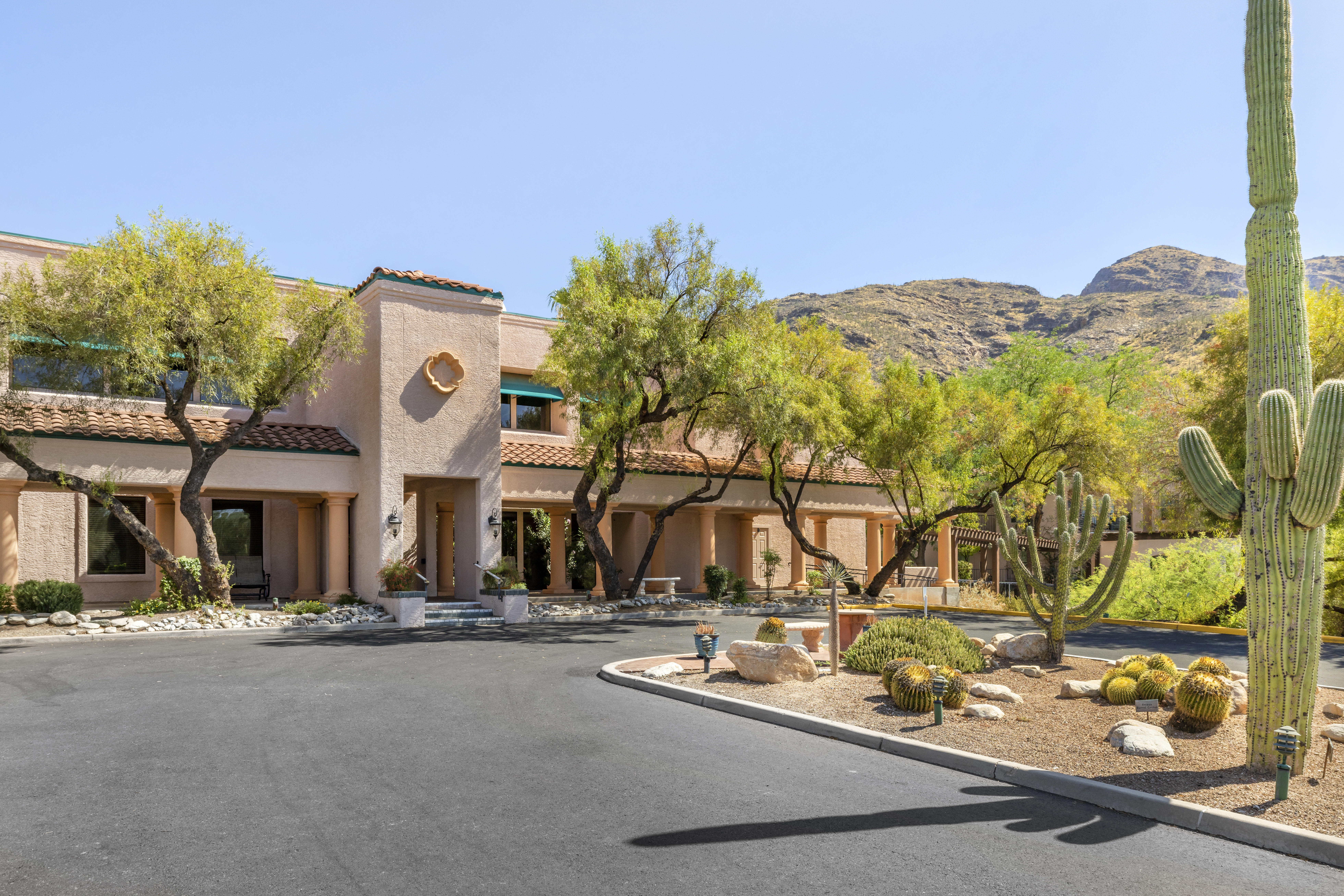 Entrance view of the facility with desert landscaping