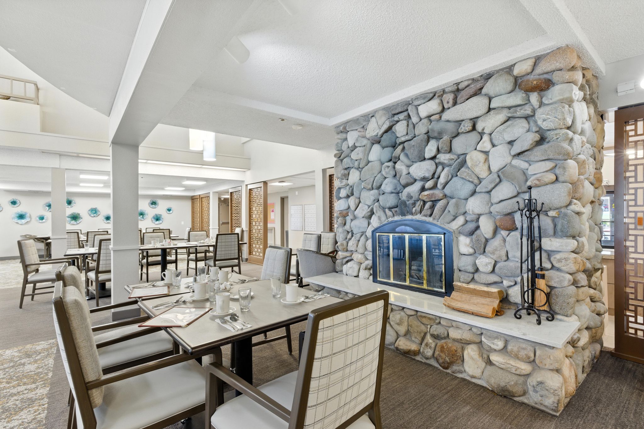 Interior dining area with stone fireplace and tables
