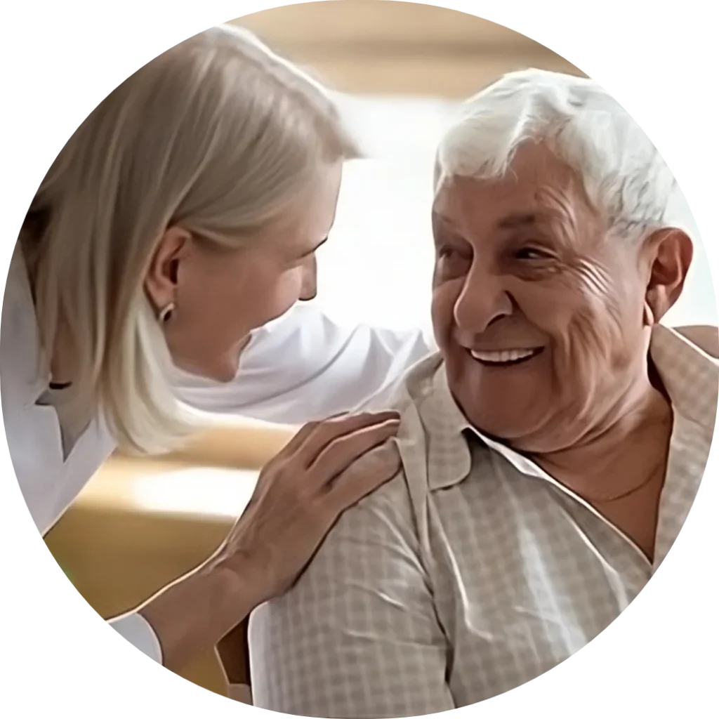 A caregiver and a senior resident smiling together.