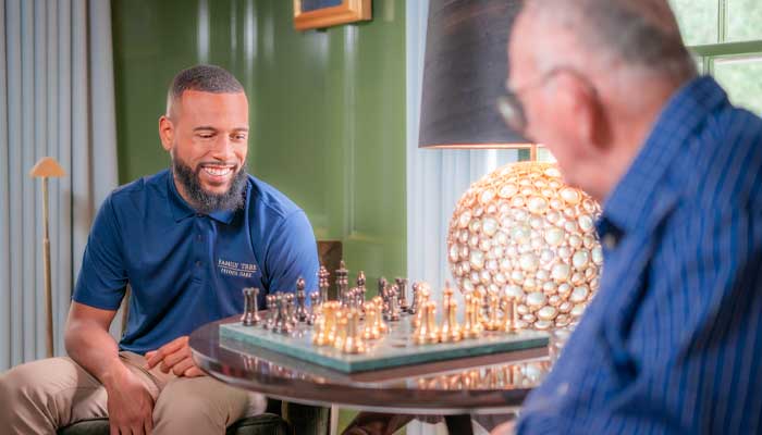 Senior resident and staff member playing chess
