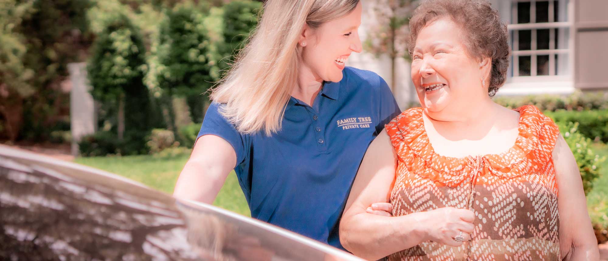 Caregiver and resident enjoying time outdoors.